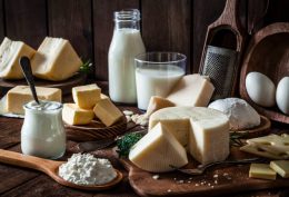 Dairy products assortment shot on rustic wooden table. Dairy products included are milk, yogurt, butter, goat cheese, mozzarella, ricotta, Parmesan cheese, emmental cheese, eggs and hard cheese. Low key DSRL studio photo taken with Canon EOS 5D Mk II and Canon EF 100mm f/2.8L Macro IS USM