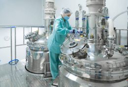 Pharmaceutical technician in sterile environment at pharmacy industry